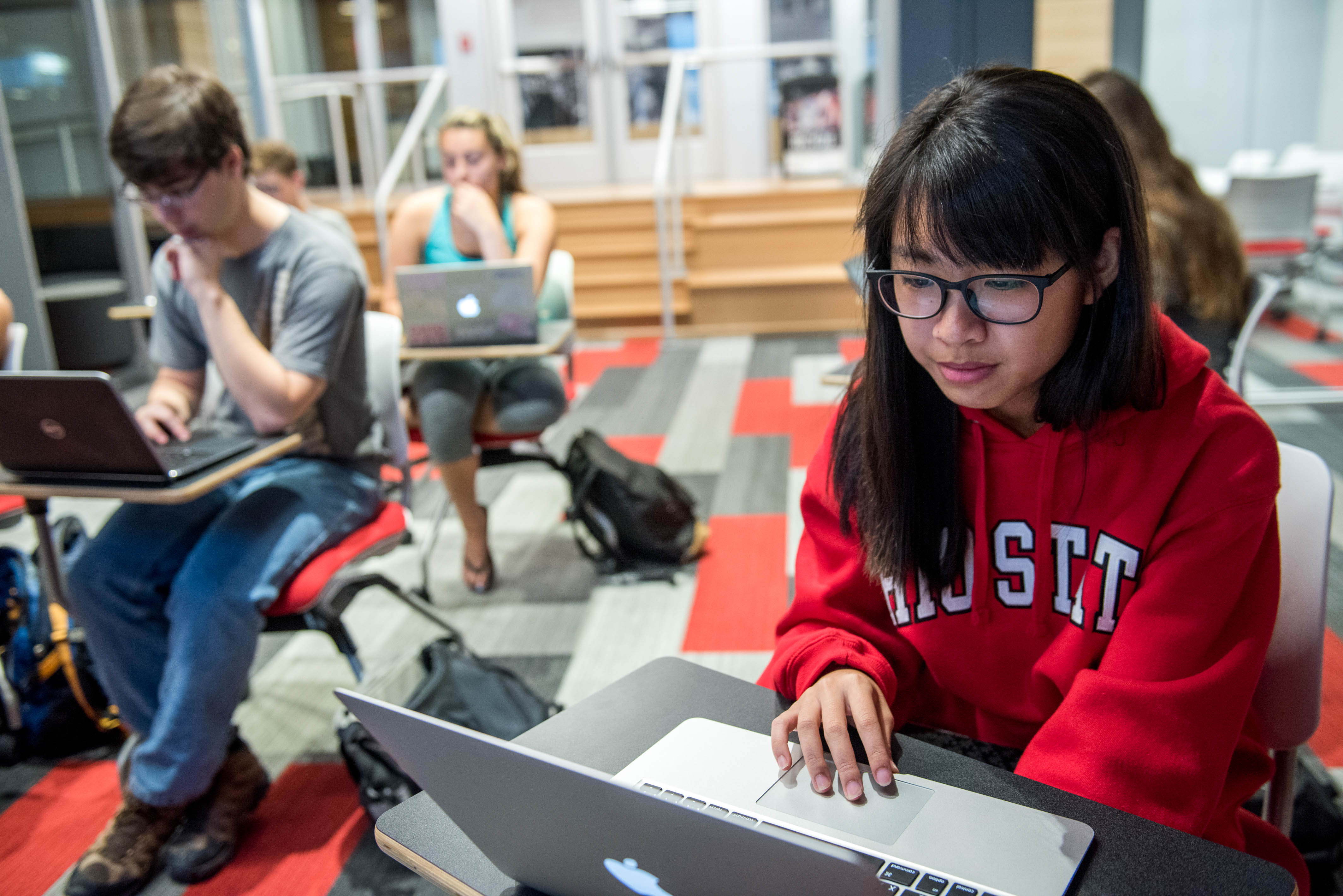 Ohio State students are working on laptops individually in a classroom.