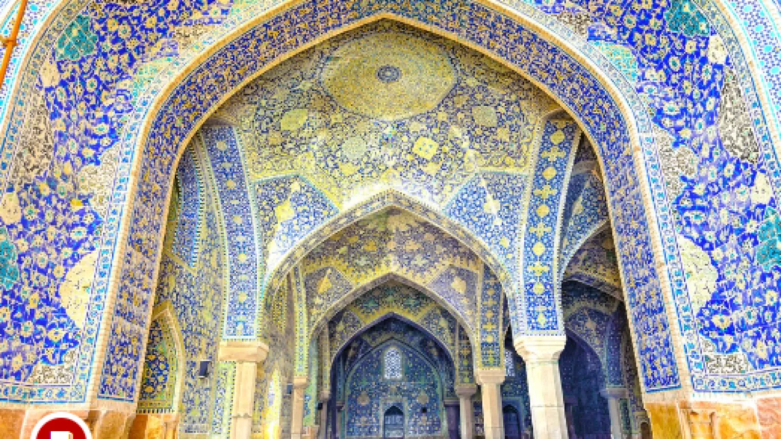 Interior mosque chamber with walls colored in bright blues, greens, and yellows