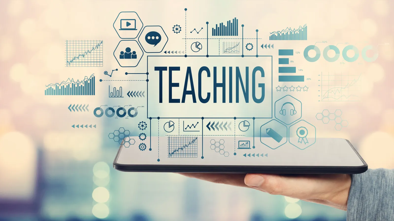 A tablet with the word "Teaching" hovering over it surrounded by digital icons