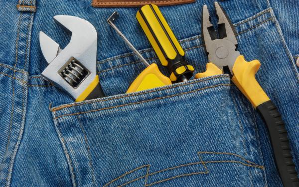 Wrench, Pliers, and a Screwdriver in back pocket of pants