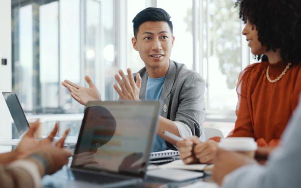 People having a discussion with computers on the table