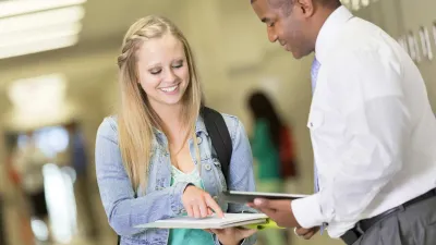 Female student and male professor looking at a document together