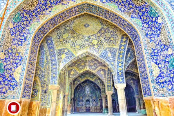 Interior mosque chamber with walls colored in bright blues, greens, and yellows